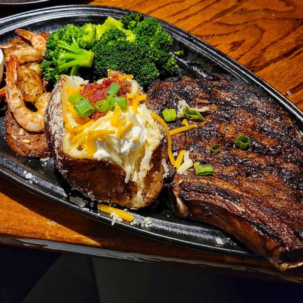 outback steakhouse platter of steak and baked potato with broccoli